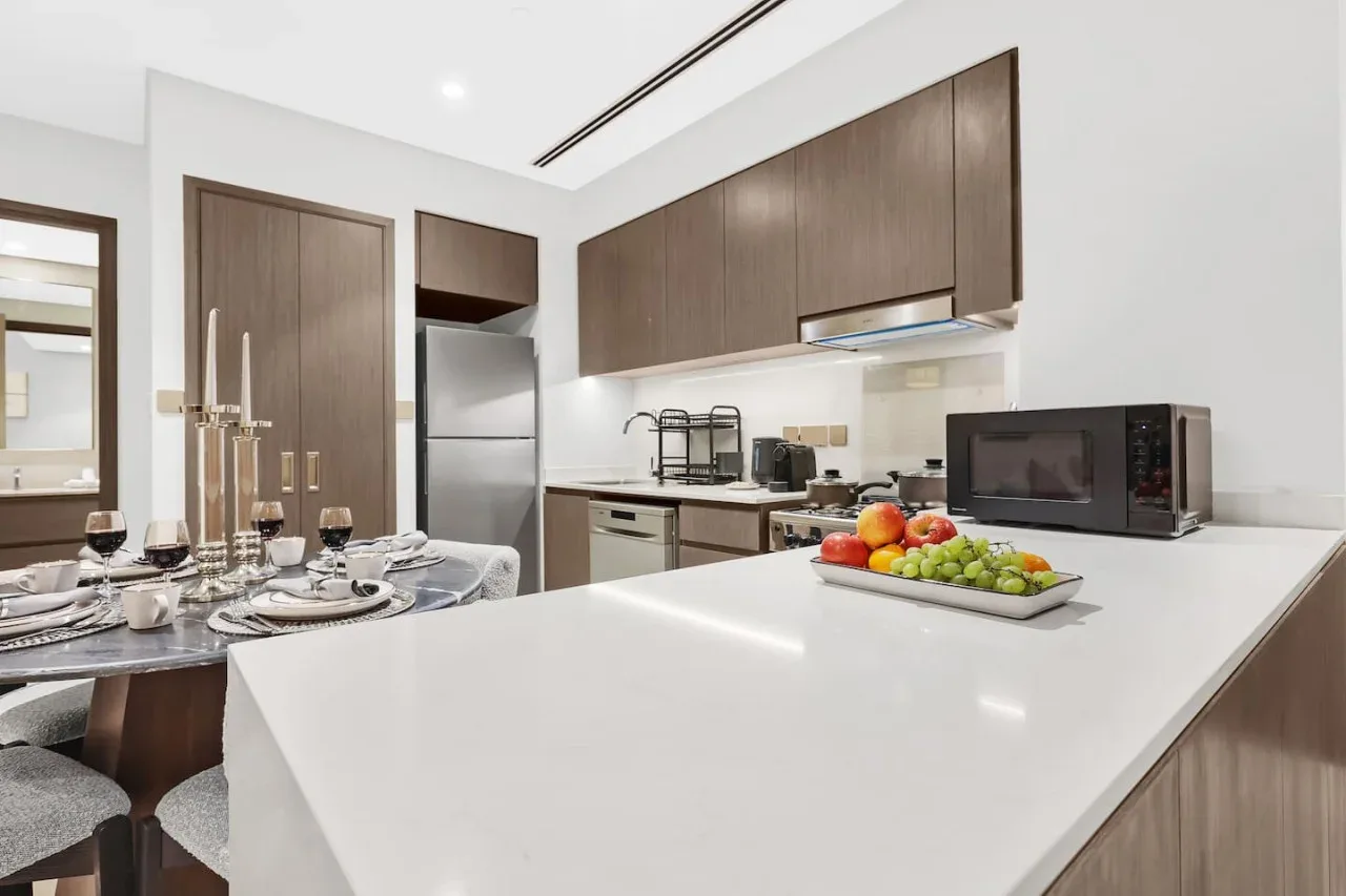 Una cocina moderna con una gran isla blanca y una mesa de comedor.