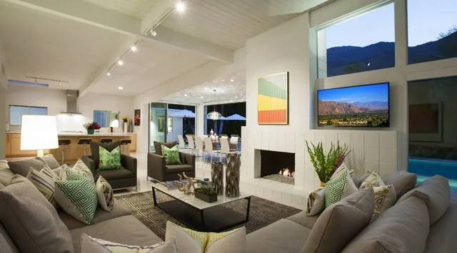 Una sala luminosa con asientos alrededor de una mesa de centro y una chimenea.