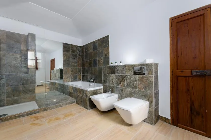 A tiled bathroom with a bathtub, sink, and toilet.