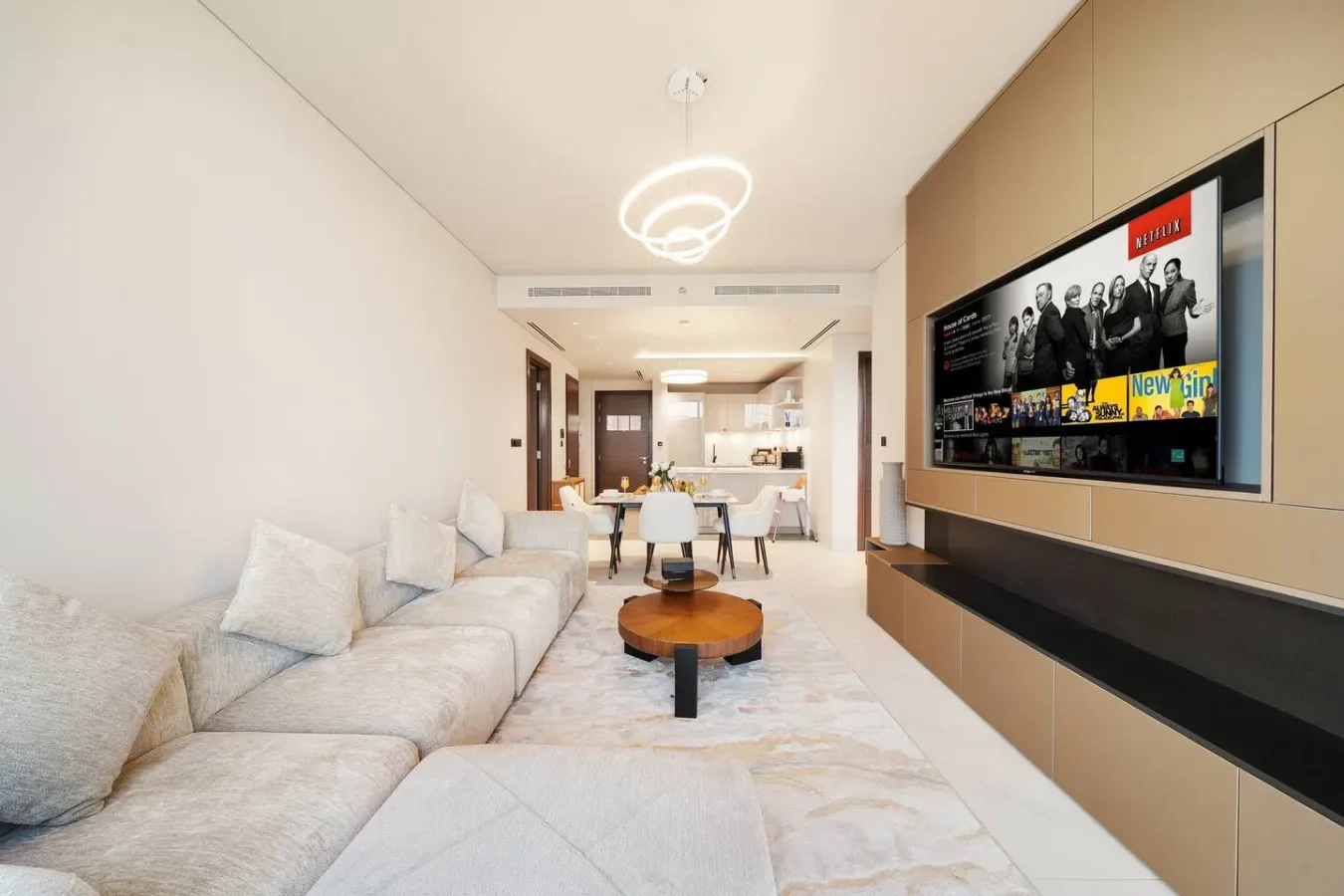 Una sala luminosa con asientos, una mesa de centro y un televisor.
