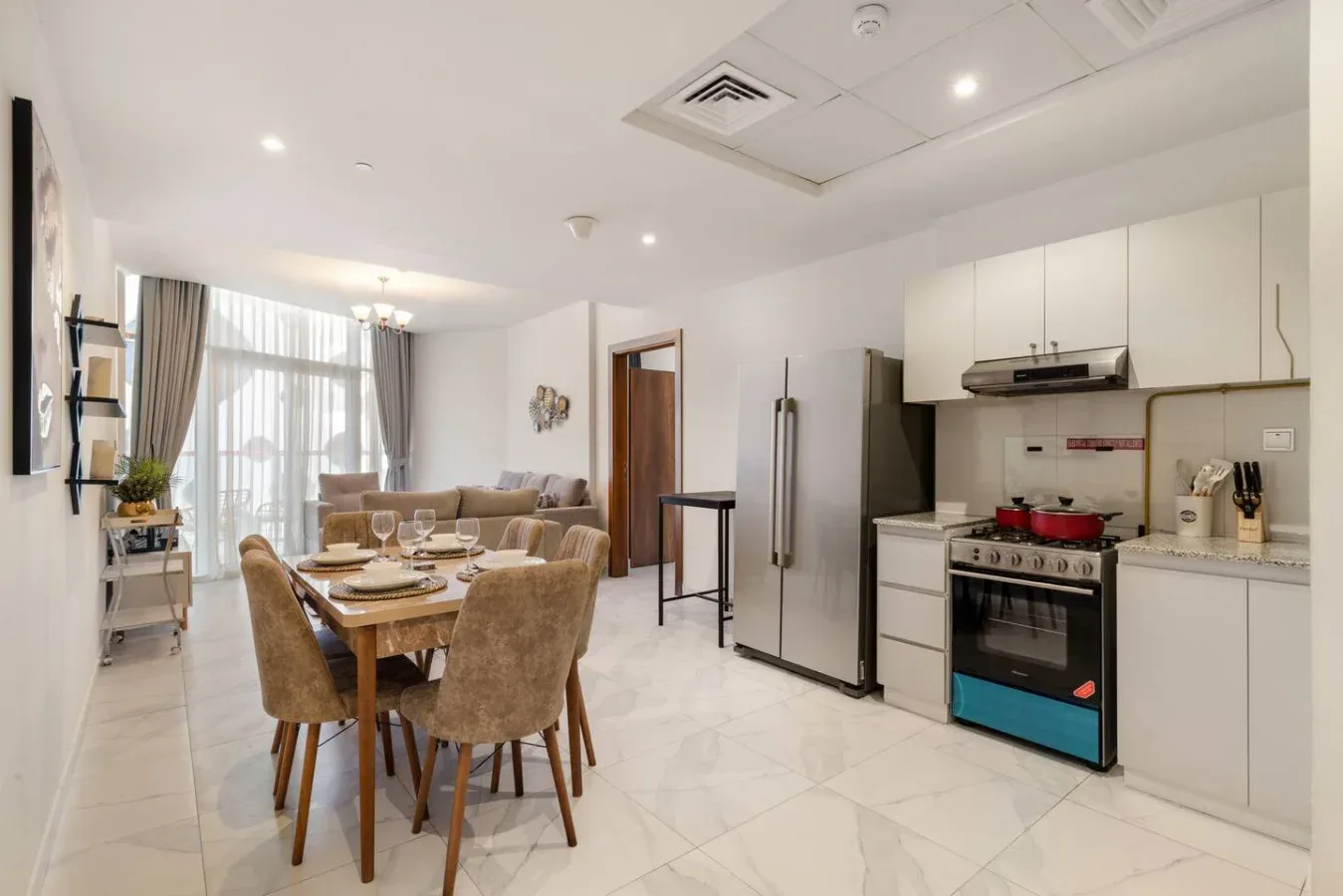 An open-plan kitchen and dining area with a table set beside the living space.