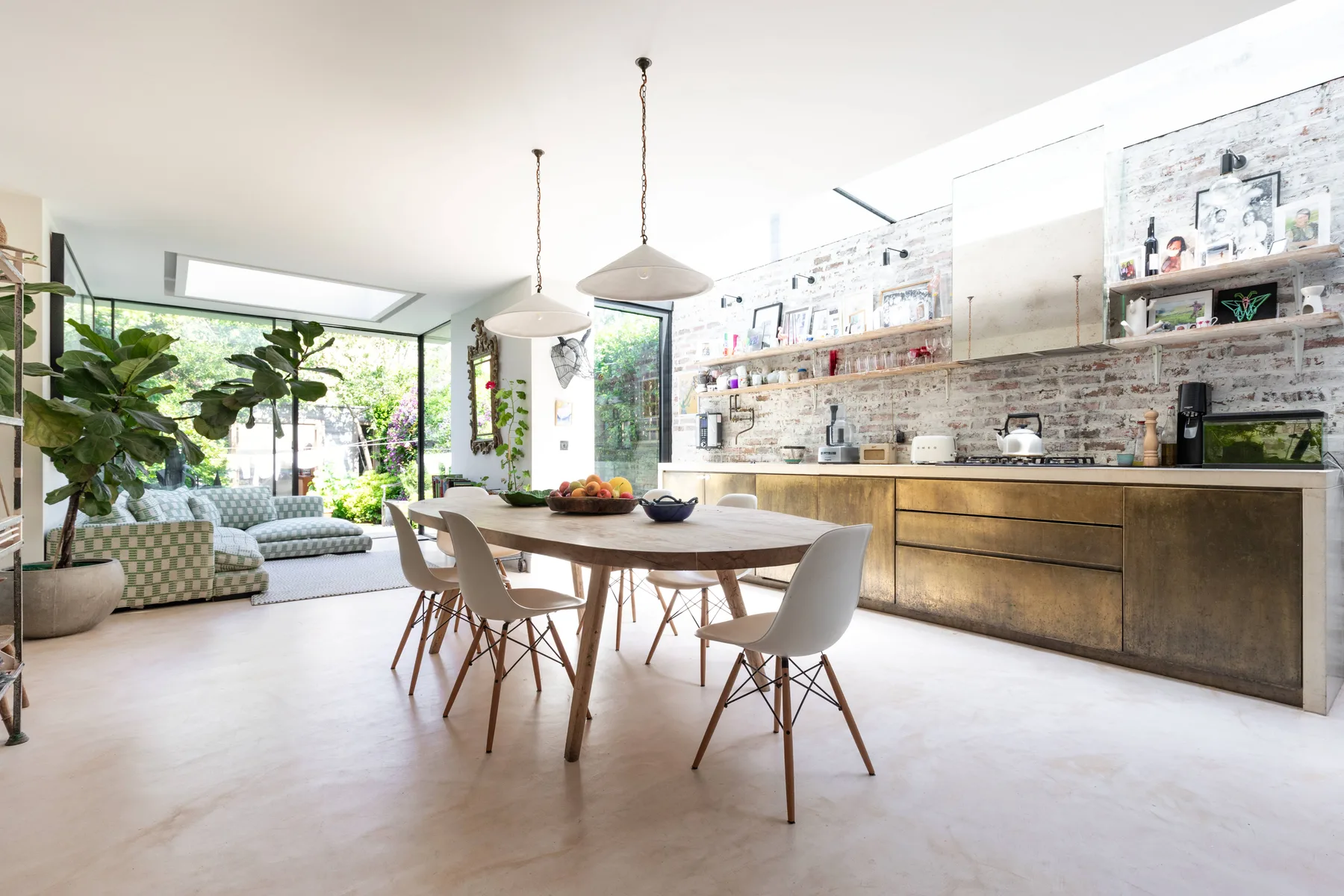 A bright open-plan kitchen and dining area with a lounge seating space.
