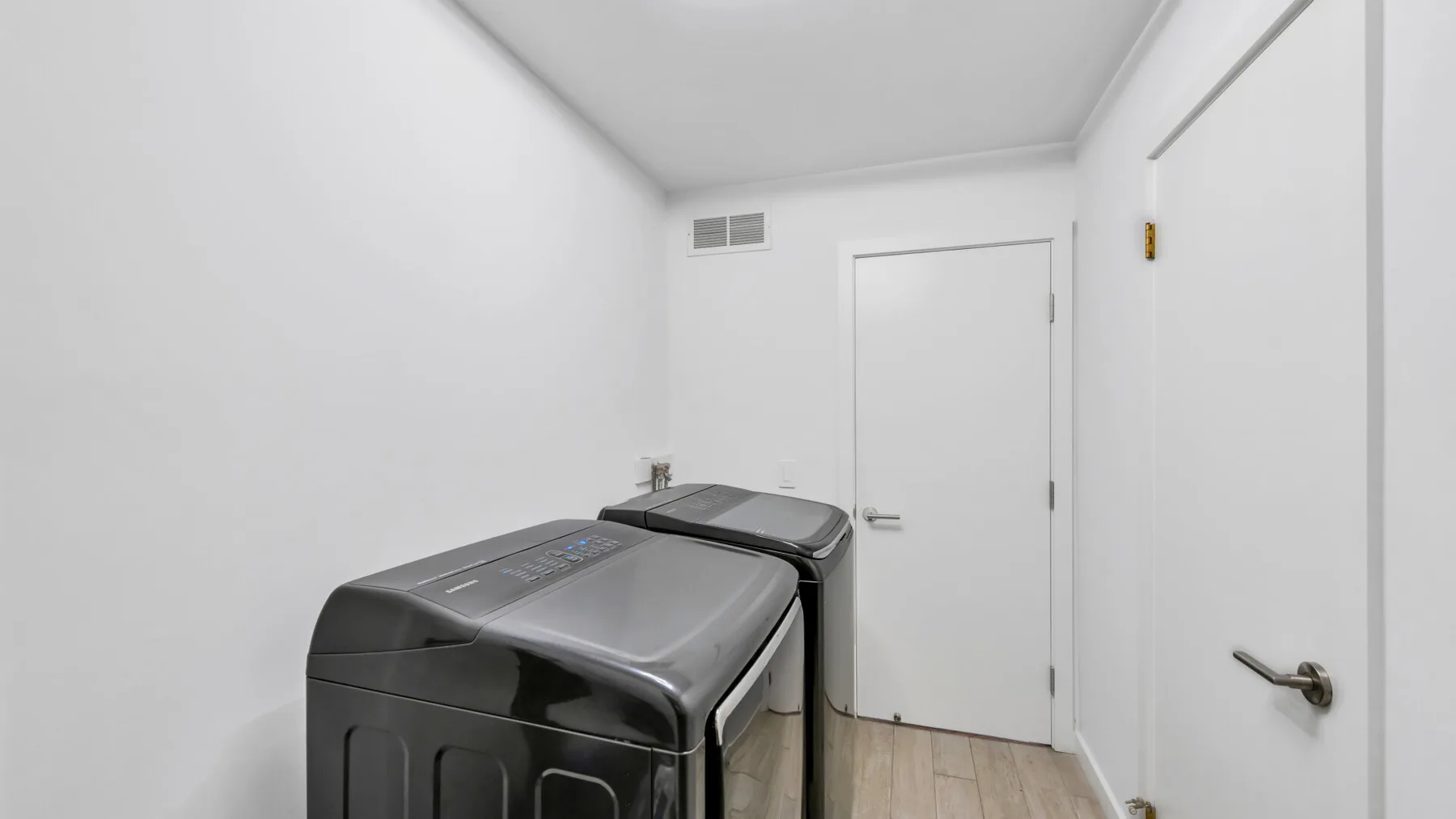 A small laundry room with a washing machine and dryer.