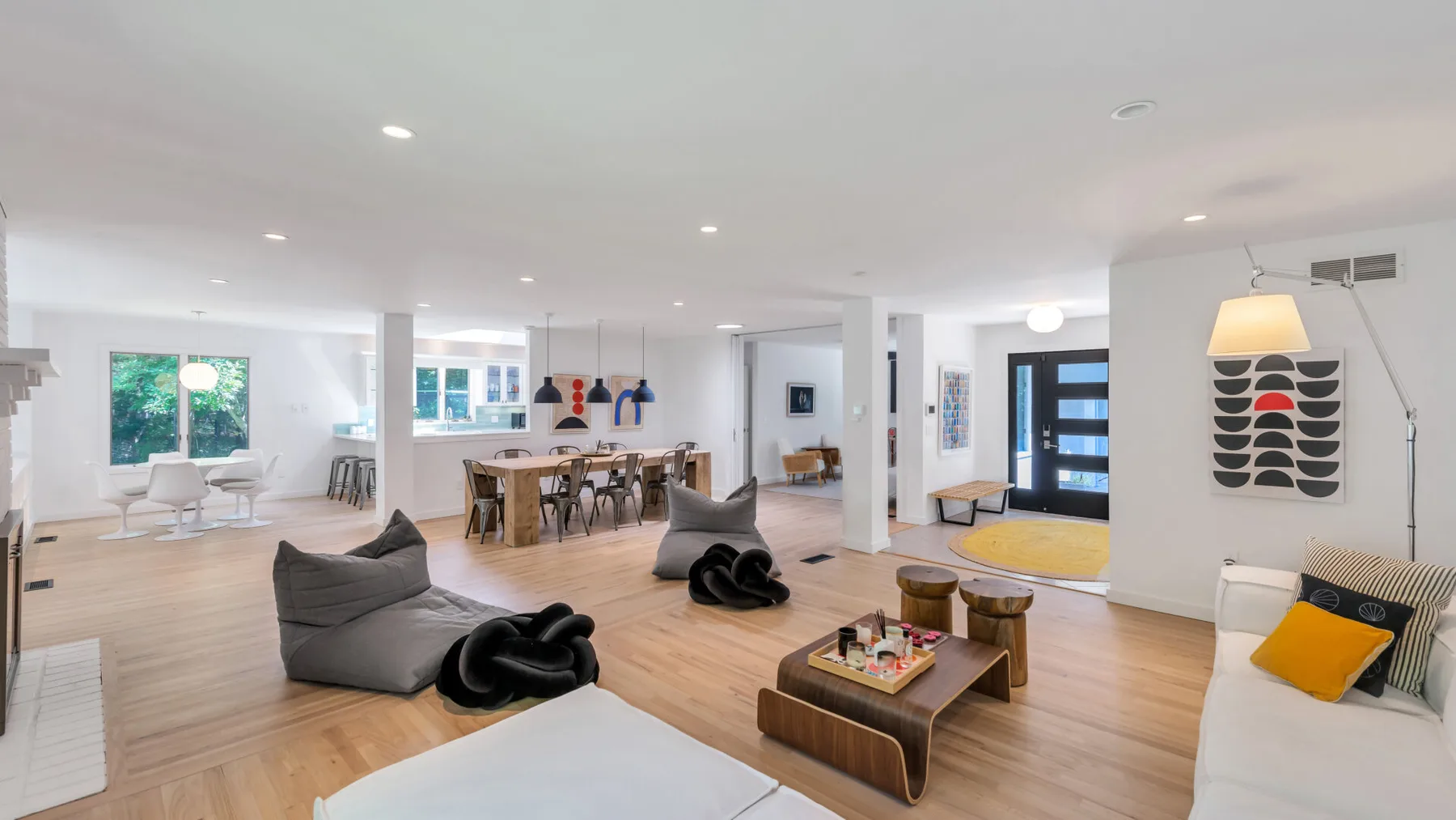 An open-plan living and dining area with seating and a wooden coffee table.