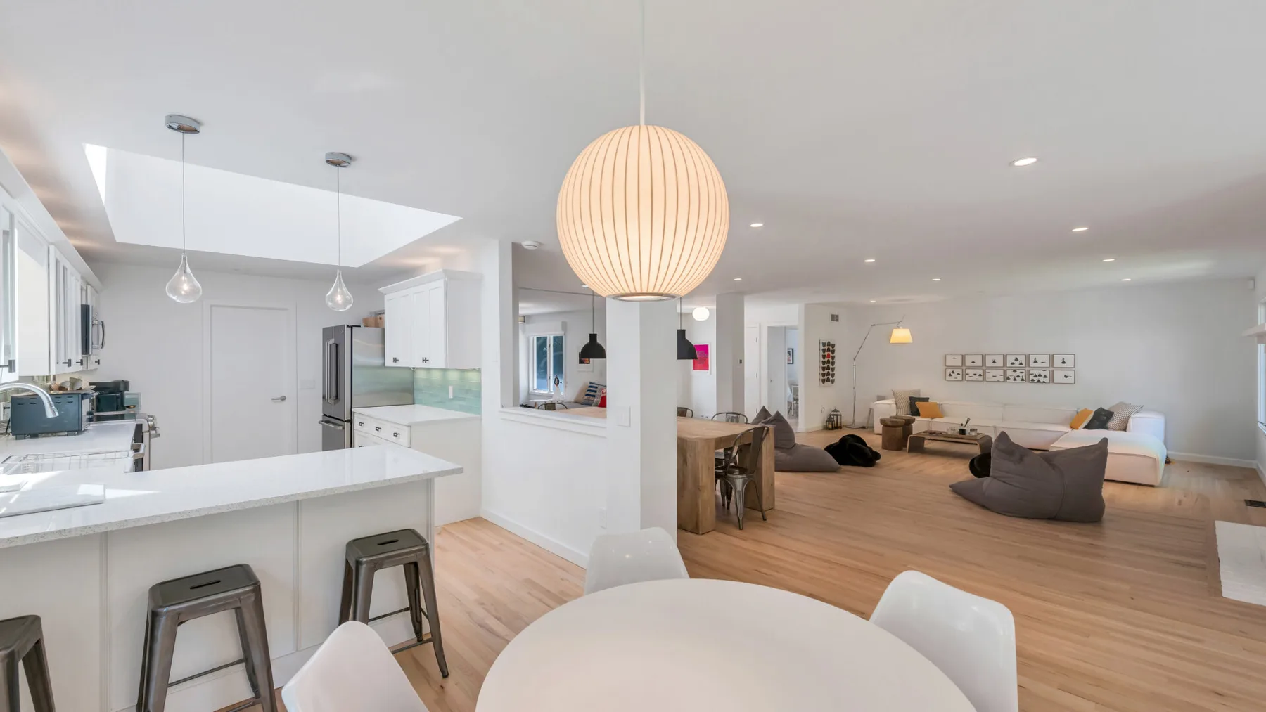 An open-plan kitchen and living area with a dining table and seating.