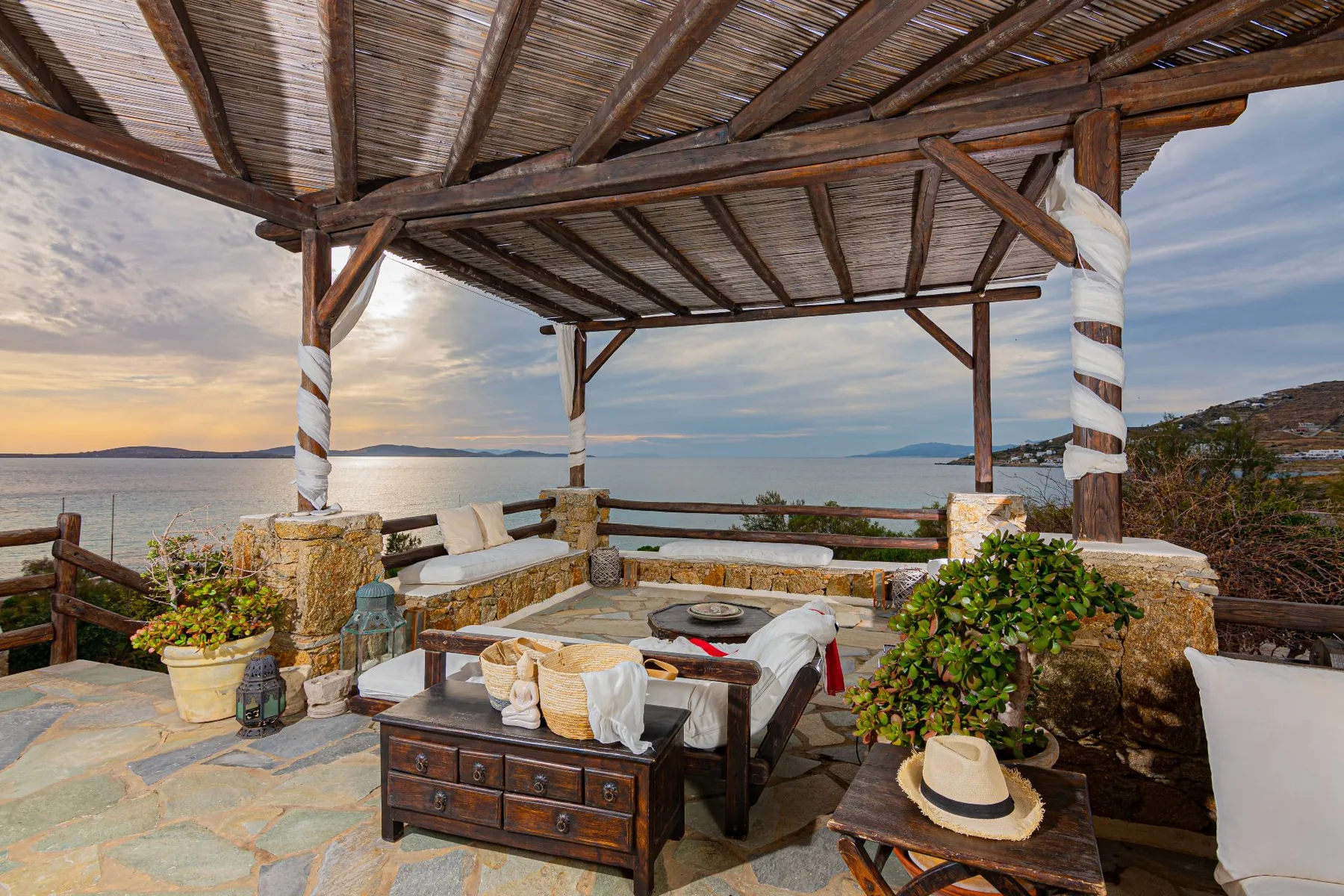 A covered outdoor seating area overlooks the water.