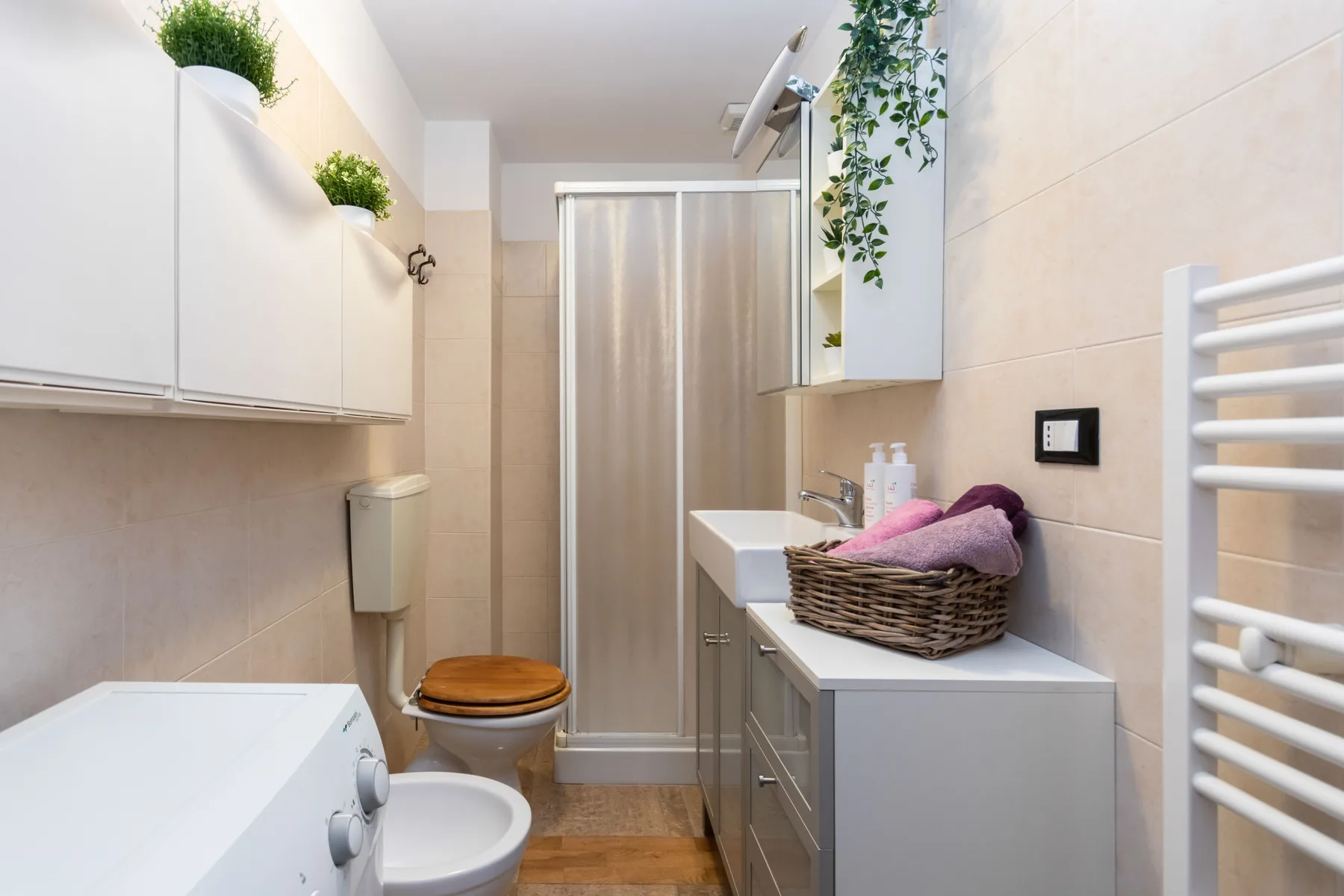 A bathroom with a shower curtain, toilet, and vanity.
