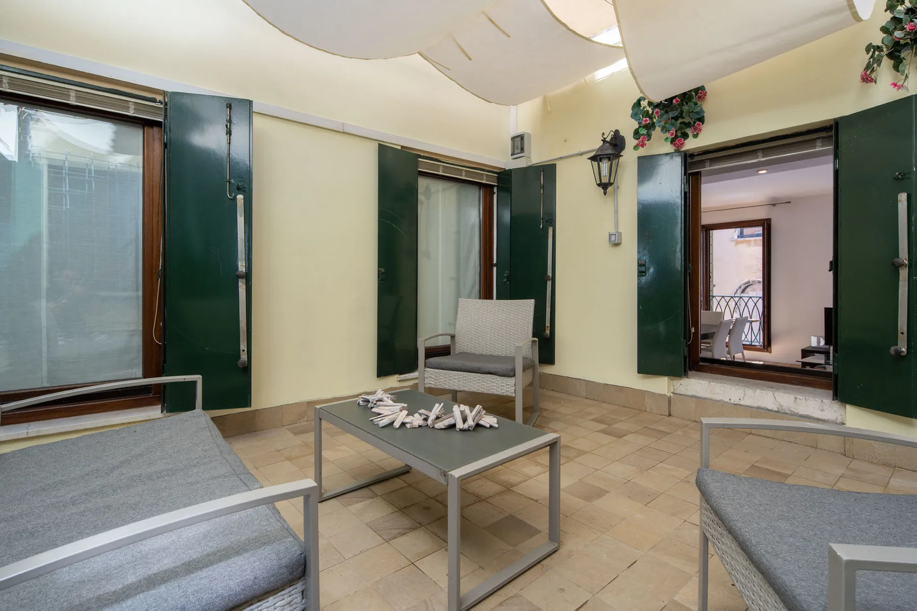 A tiled sitting area with cushioned seating around a low table.