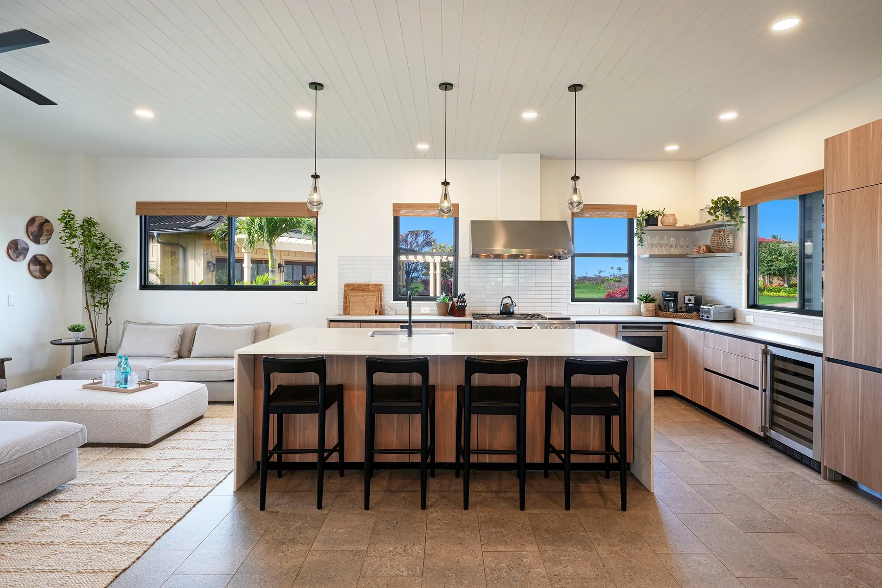 An open-plan kitchen and living area with a central island and seating.