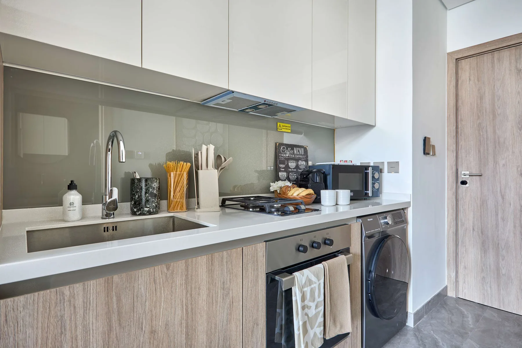 Una cocina moderna con encimera, fregadero y zona de cocción.