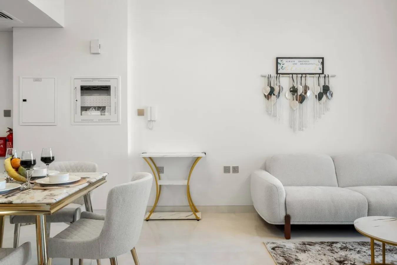 A bright living and dining area with seating and a dining table.