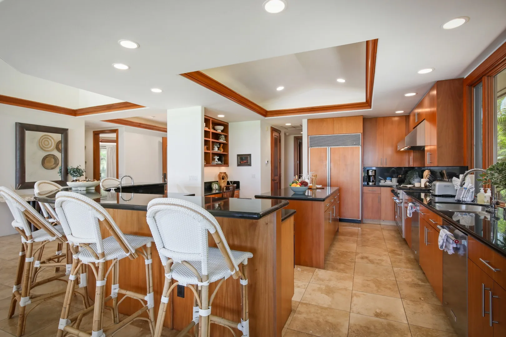 An open kitchen and dining area with a central island and counter seating.
