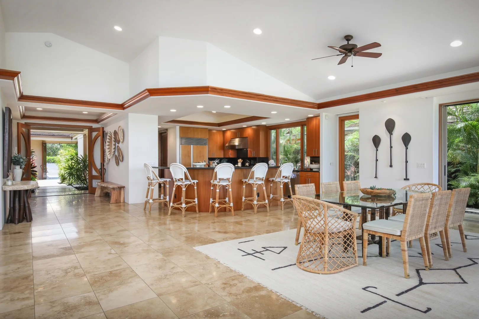 An open dining area with a table and chairs beside a kitchen island.