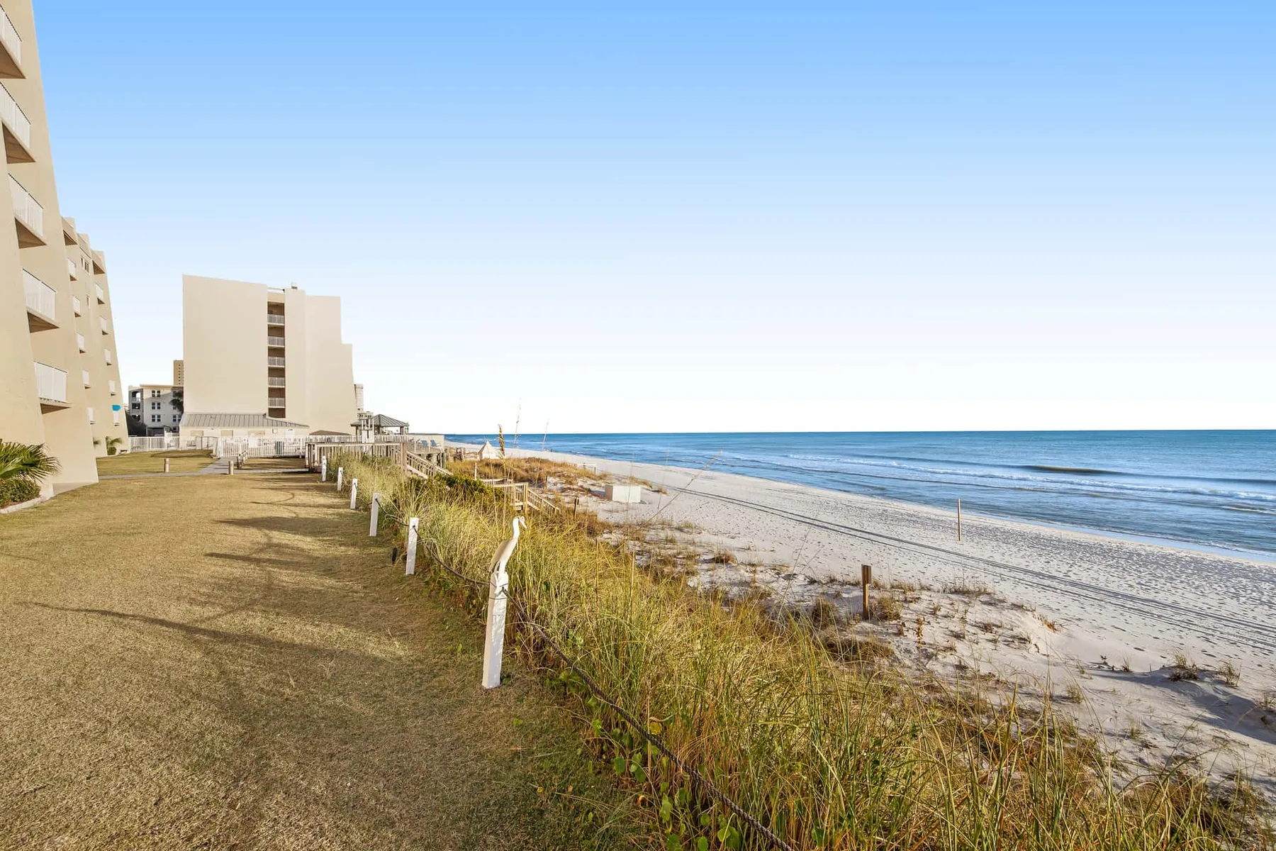 A beachfront scene with apartment buildings beside the shoreline.