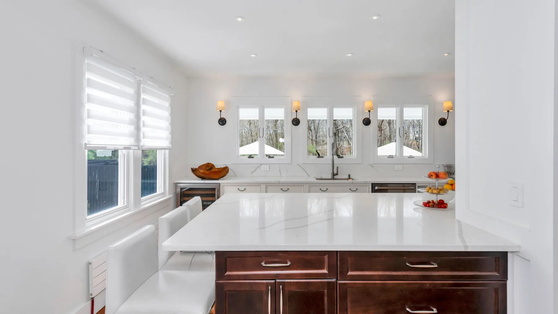 A bright kitchen with a large island and windows above the sink.