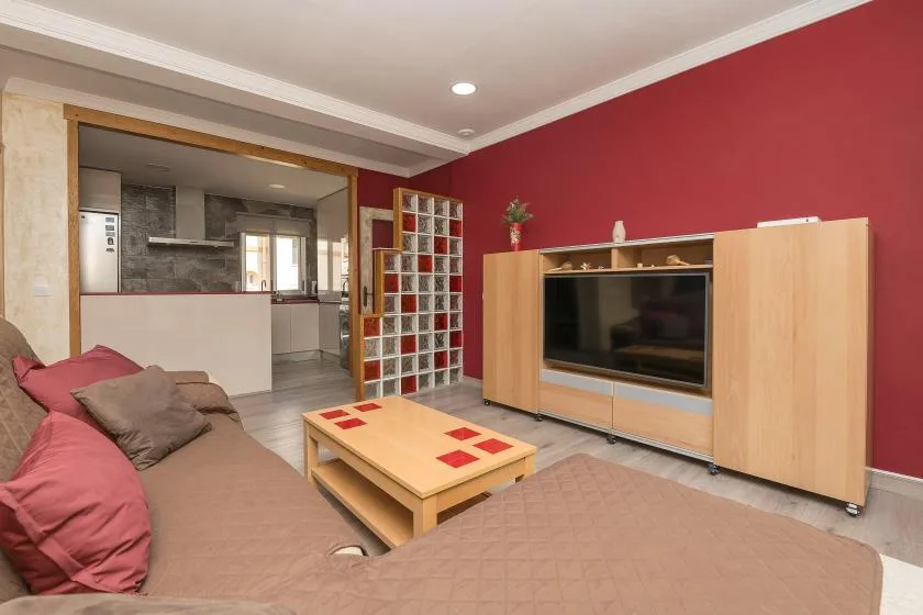 Living room with a television cabinet, coffee table, and seating.