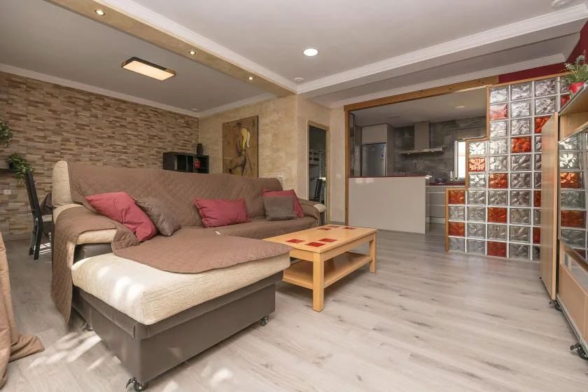 A living room with a sectional sofa and a low coffee table.