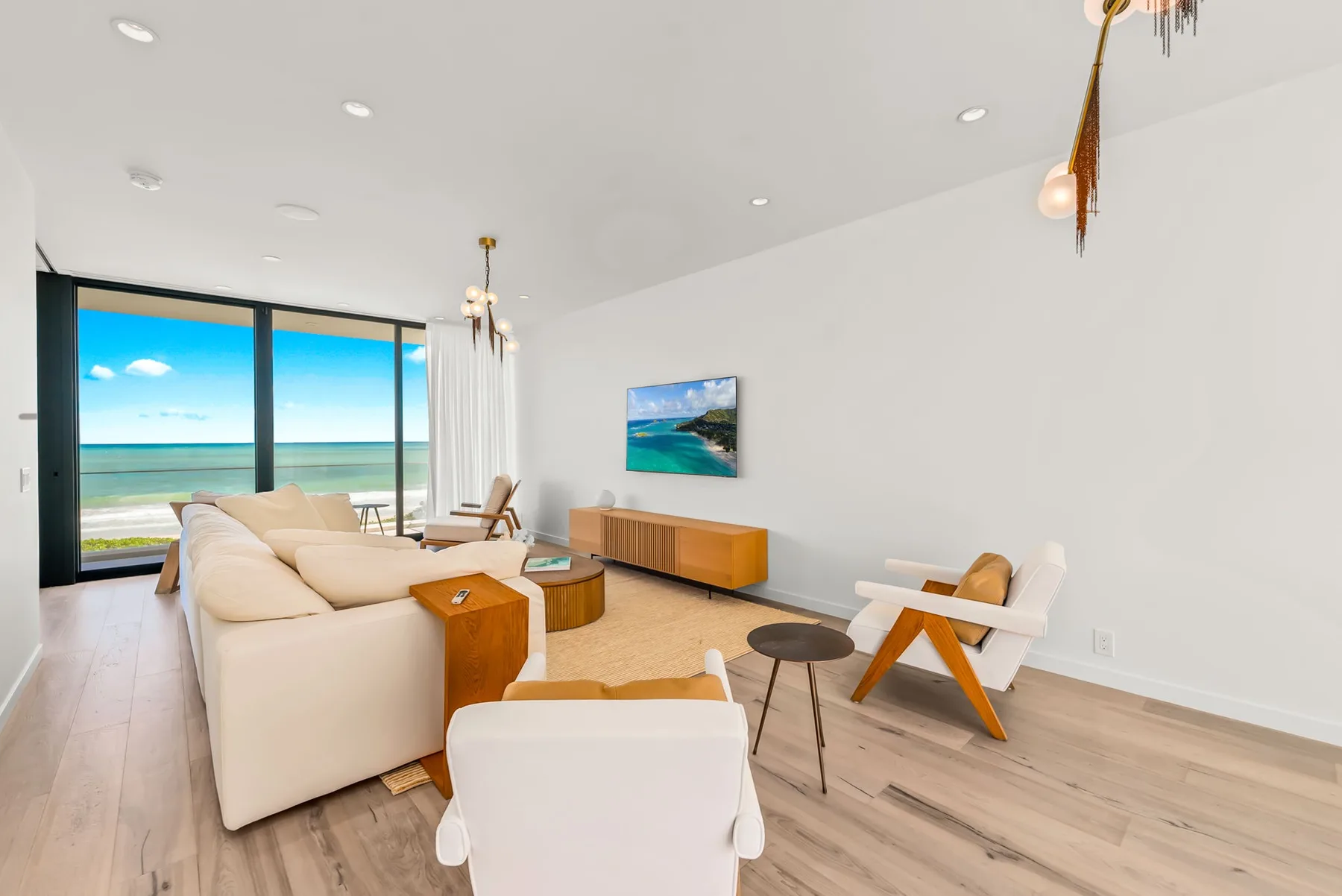 A bright living room with seating arranged around a low coffee table.