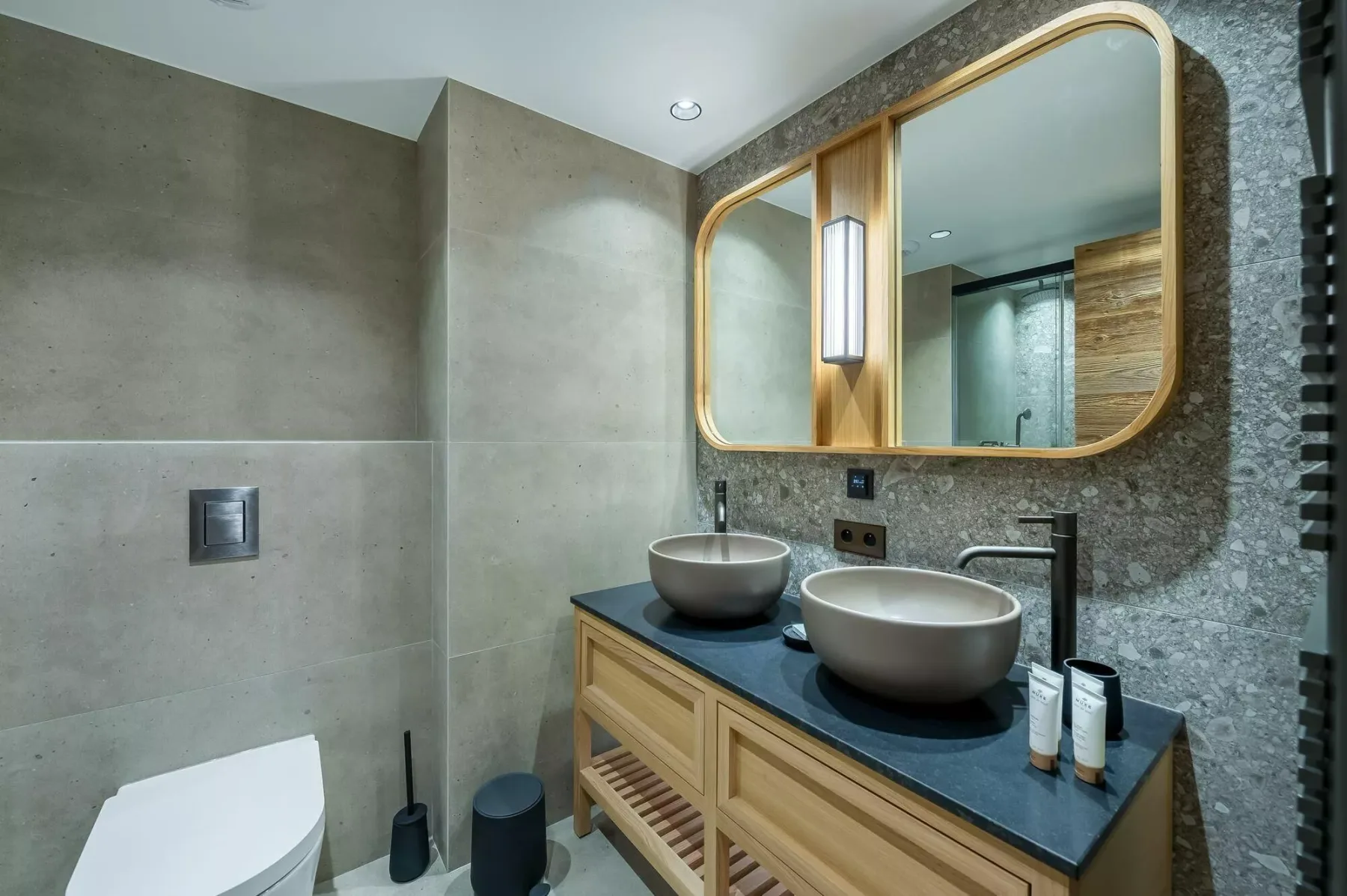 A modern bathroom with a double-sink vanity and large mirror.