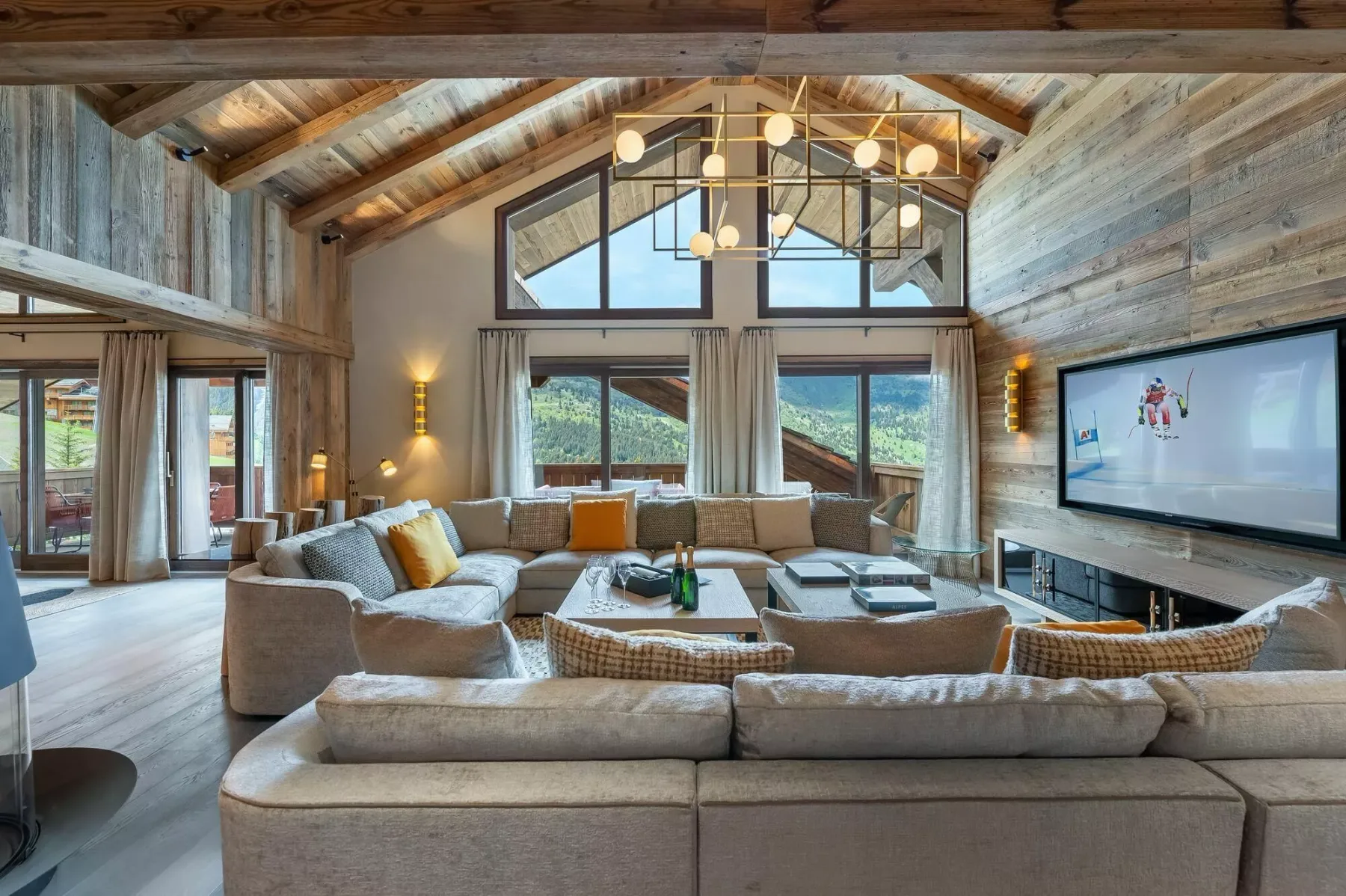 A spacious living room with seating arranged around a low coffee table.