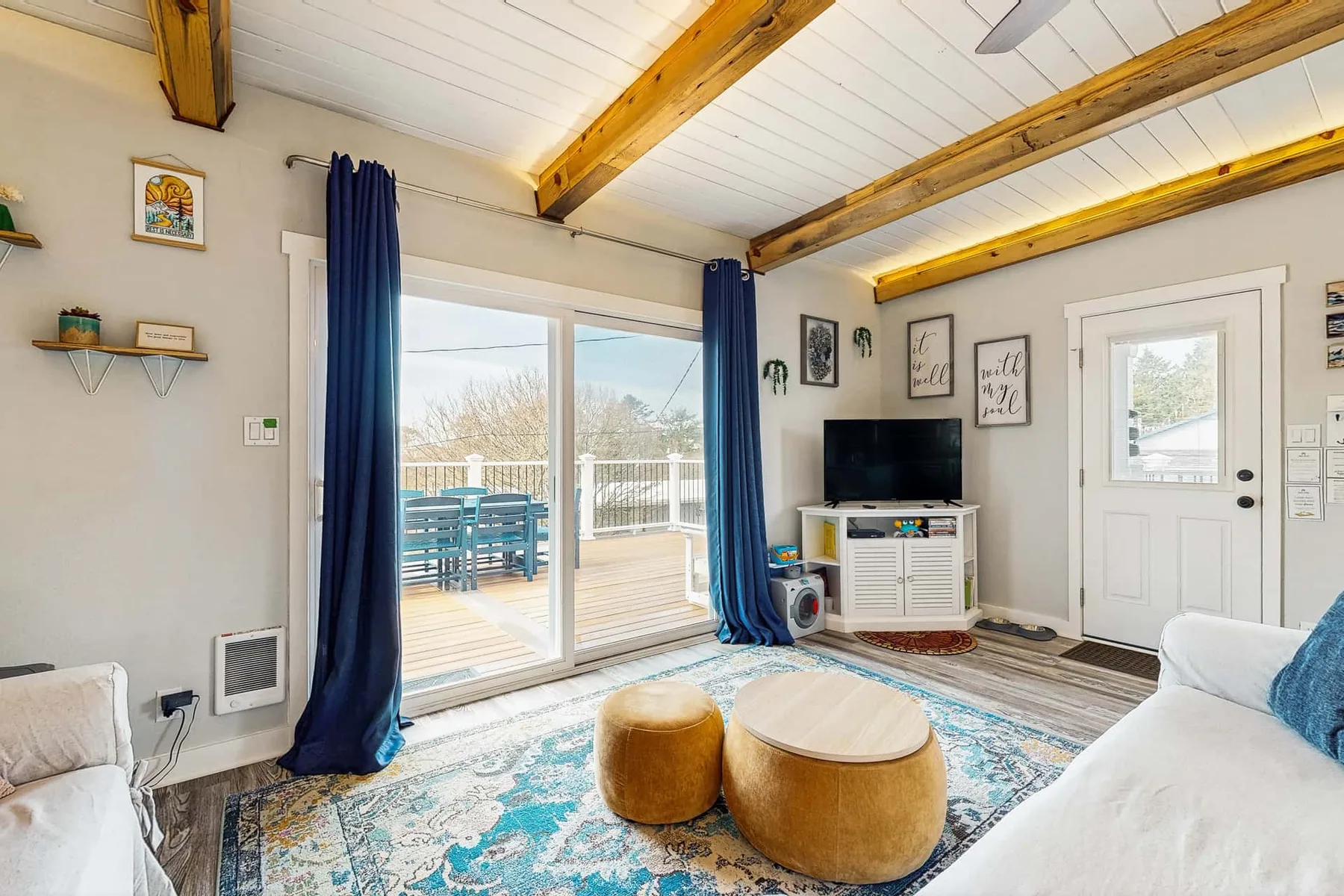 A bright living room with sliding glass doors opening onto a deck.