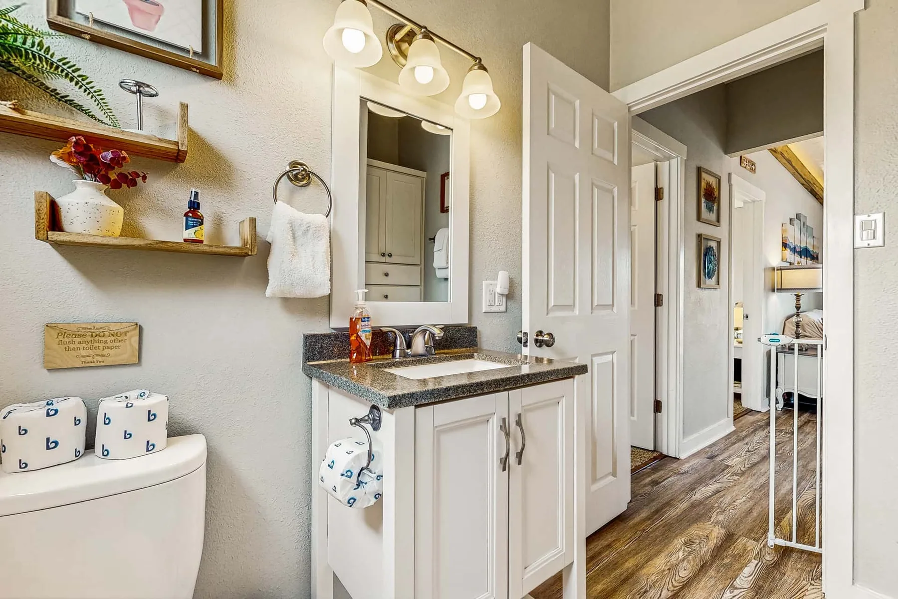 A bathroom vanity with a mirror and sink opens onto a hallway.