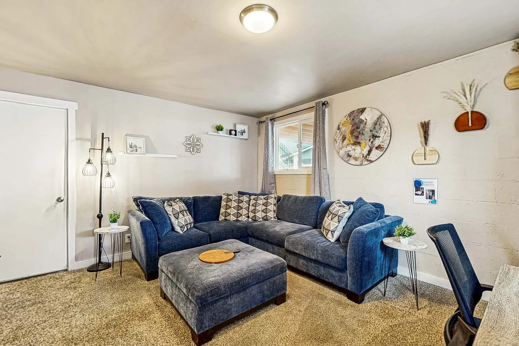 Living room with an L-shaped seating area and a matching ottoman.
