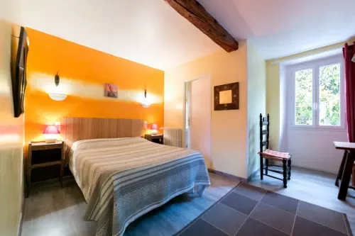 Guest room with orange décor and a garden view.