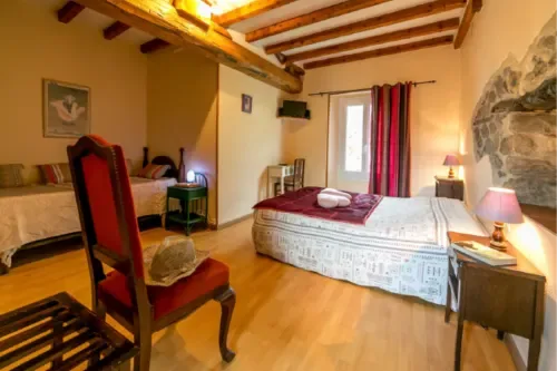 Rustic guest room with exposed beams and mountain views.