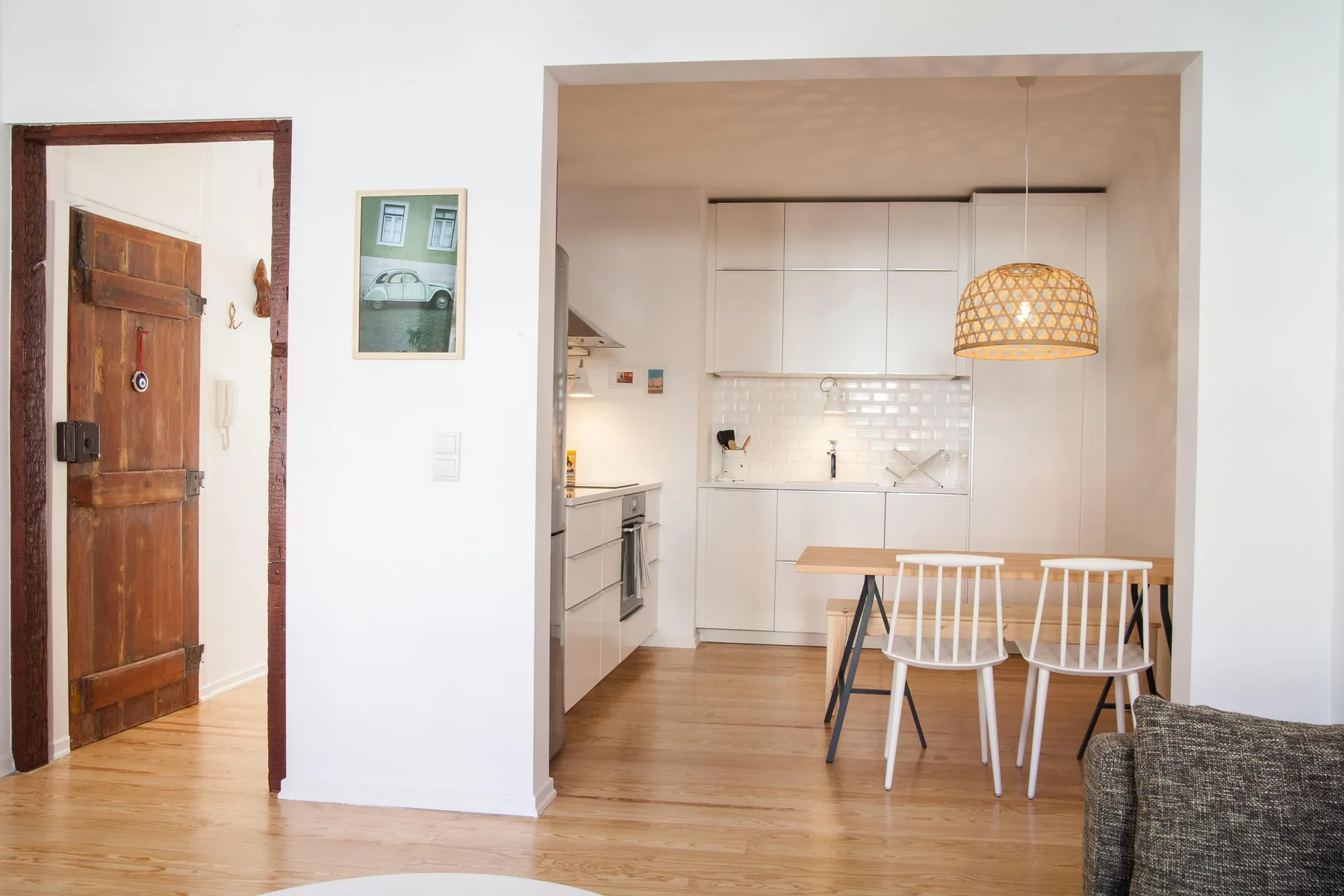 An open-plan kitchen and dining area with a table and chairs.