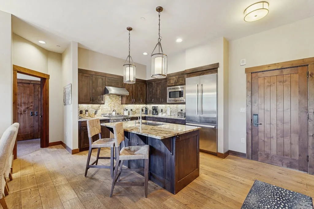 A kitchen with a central island and wooden cabinets.