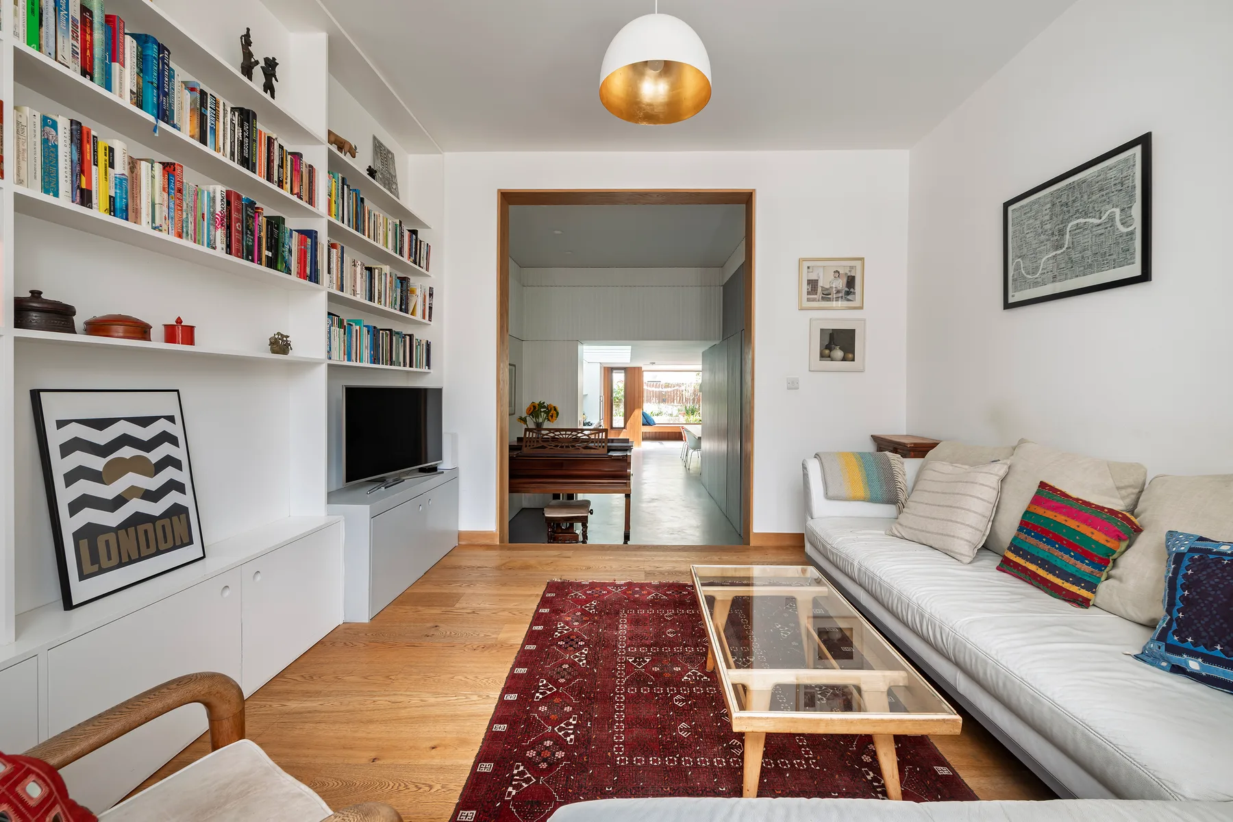 A bright living room with built-in bookshelves and a seating area.
