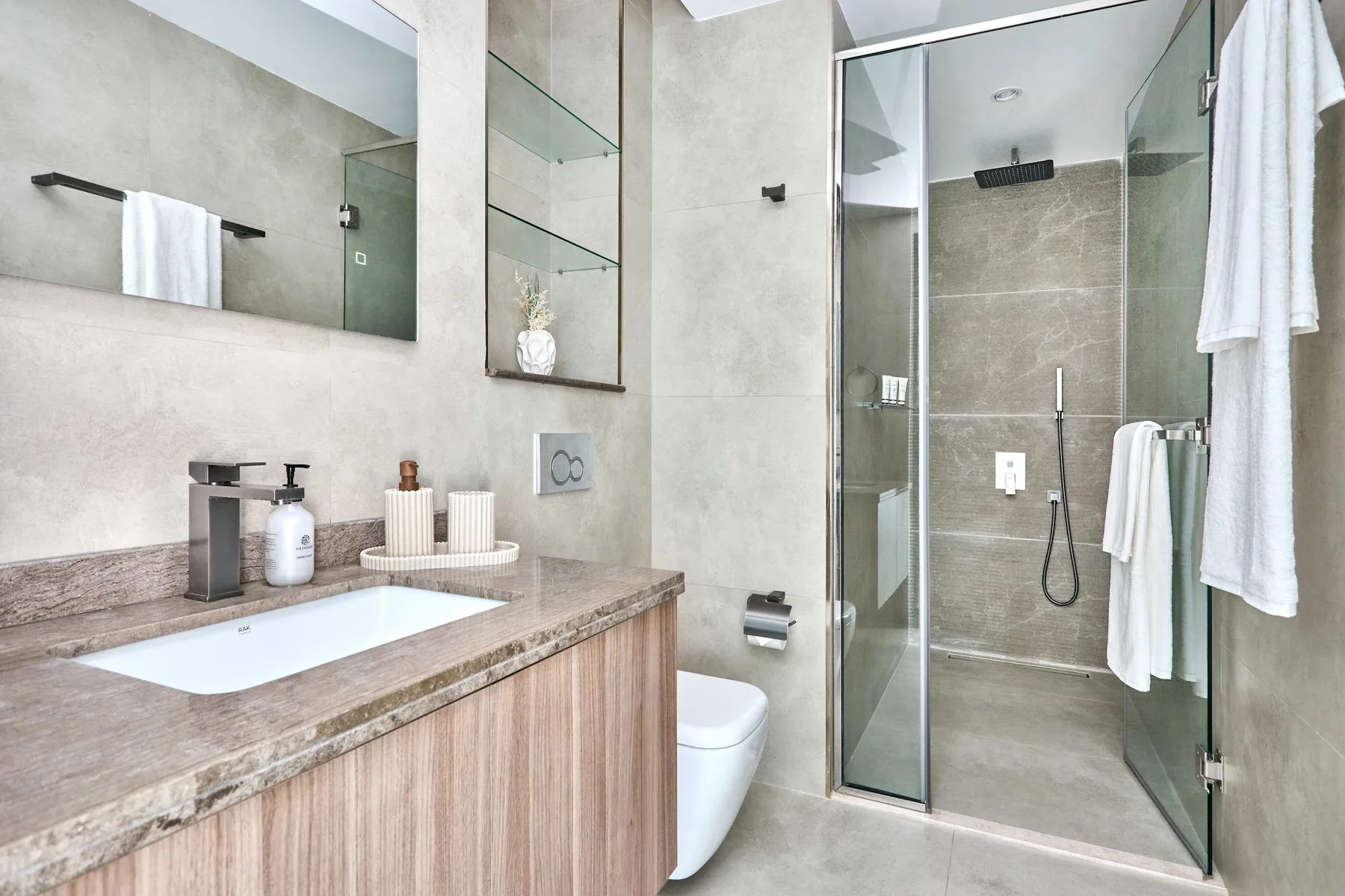 Un baño moderno con lavabo y ducha acristalada.