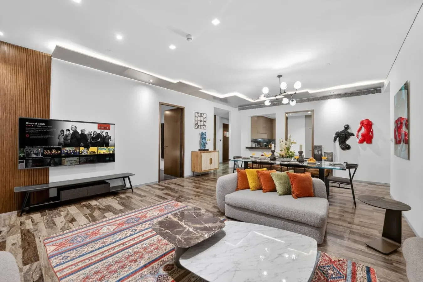 A bright living room with a sofa, coffee table, and dining area.