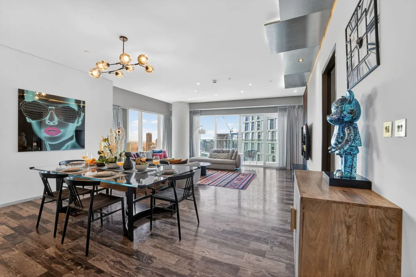 A modern dining and living area with a glass dining table and seating.