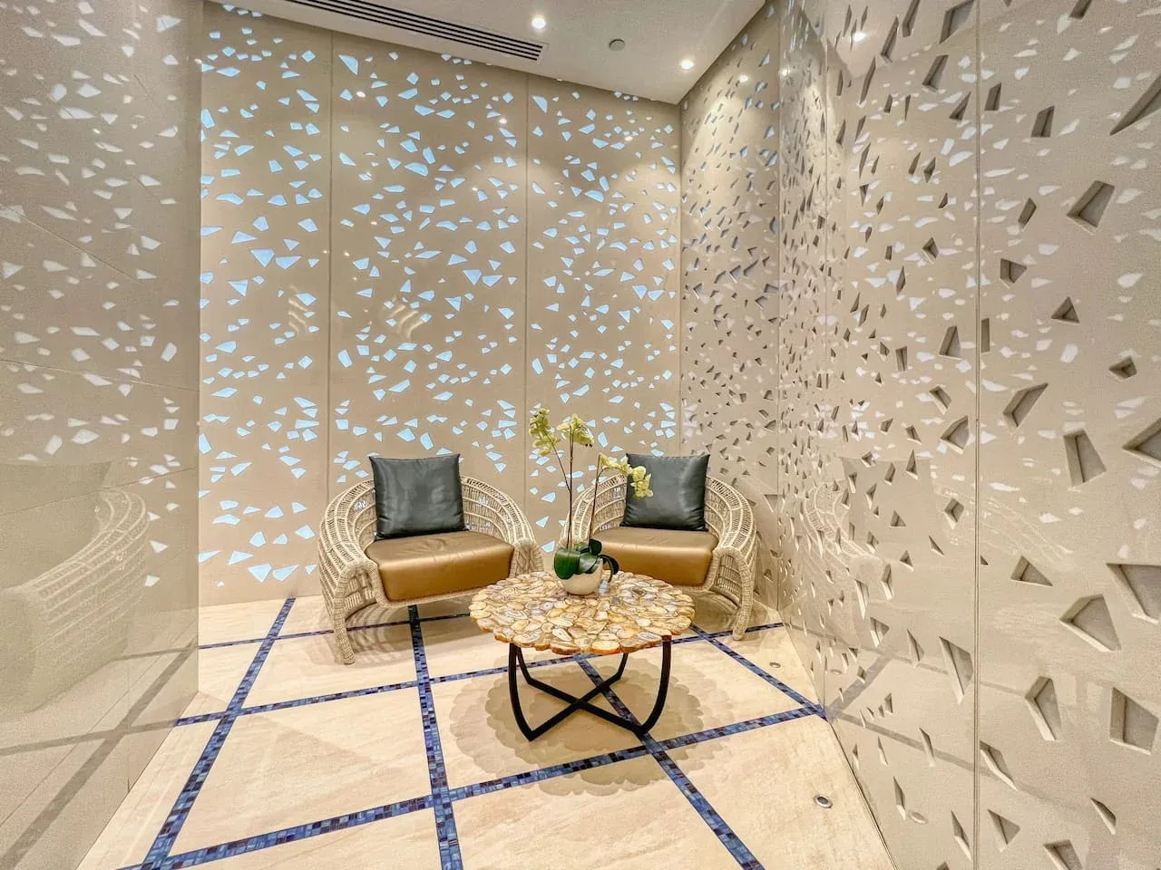 A small lounge area with woven seating and a round coffee table.