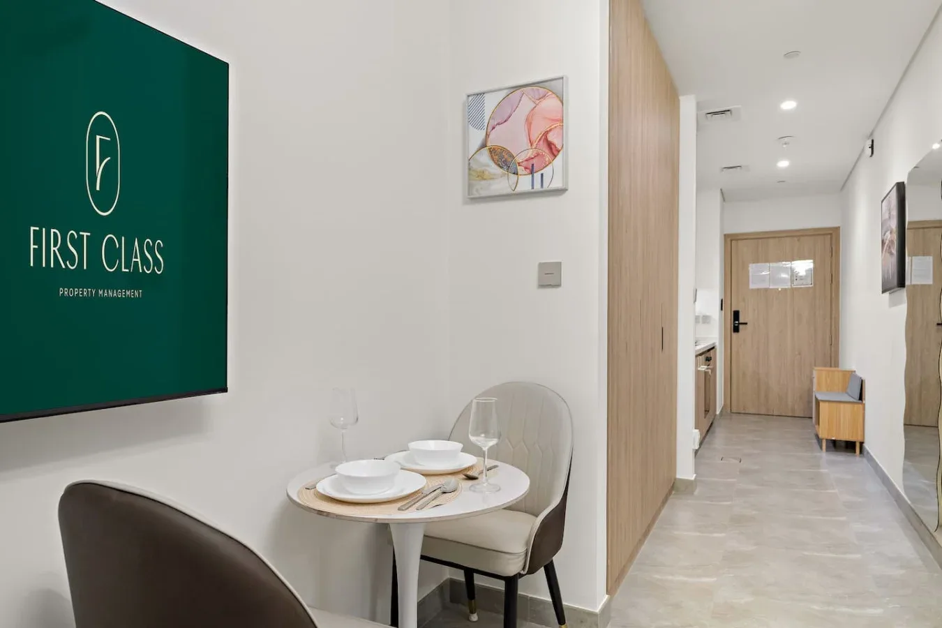 A dining nook with a small round table and a hallway beyond.