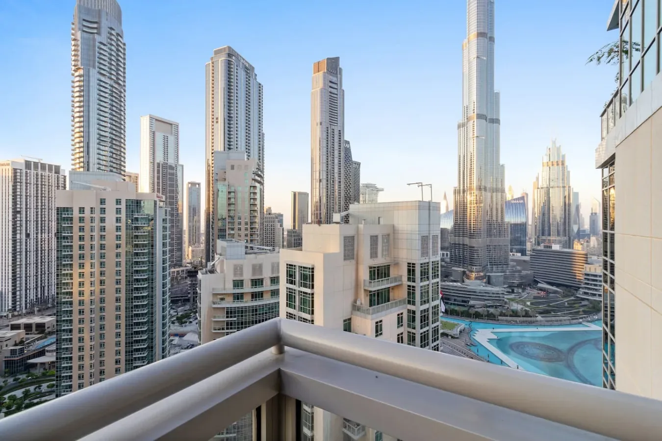 A balcony overlooks a cluster of modern high-rise buildings in the city.