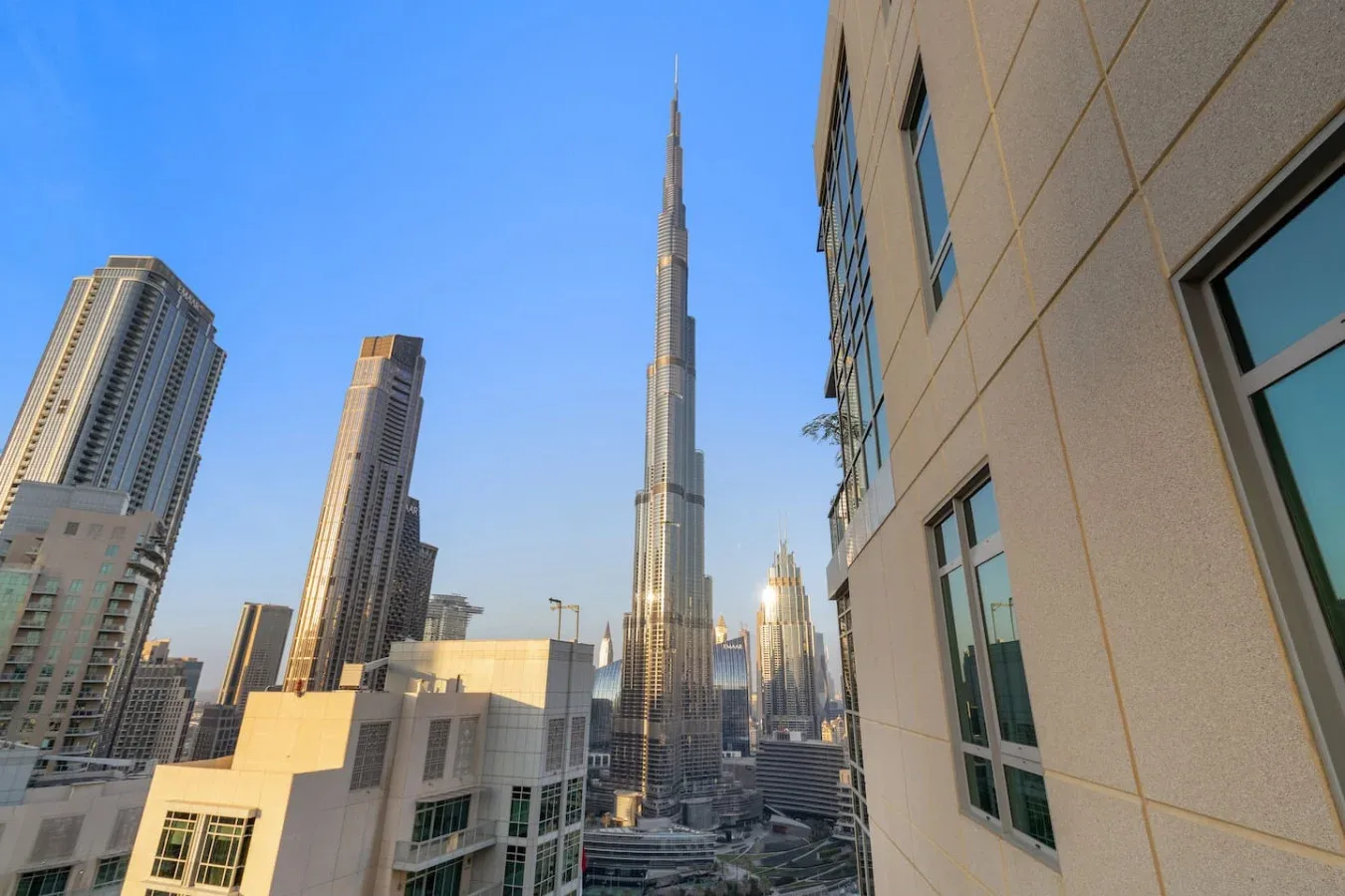 City skyline with a very tall central tower and nearby high-rise buildings.
