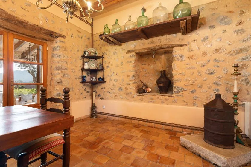 A rustic dining room with a wooden table and stone walls.