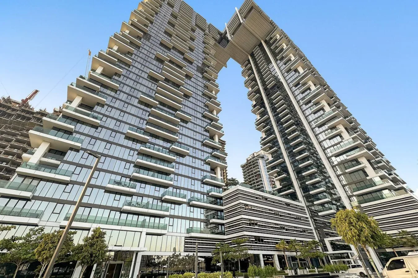 Modern high-rise buildings with glass facades and projecting balconies.