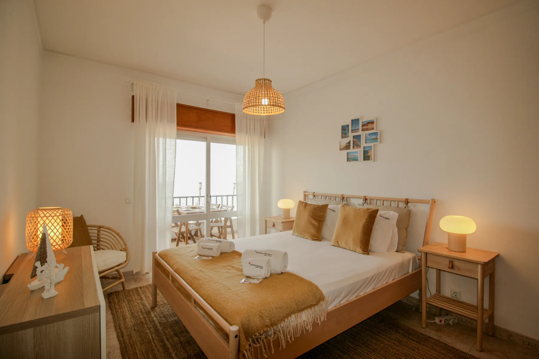 A bedroom with a bed, bedside tables, and a balcony visible through glass doors.