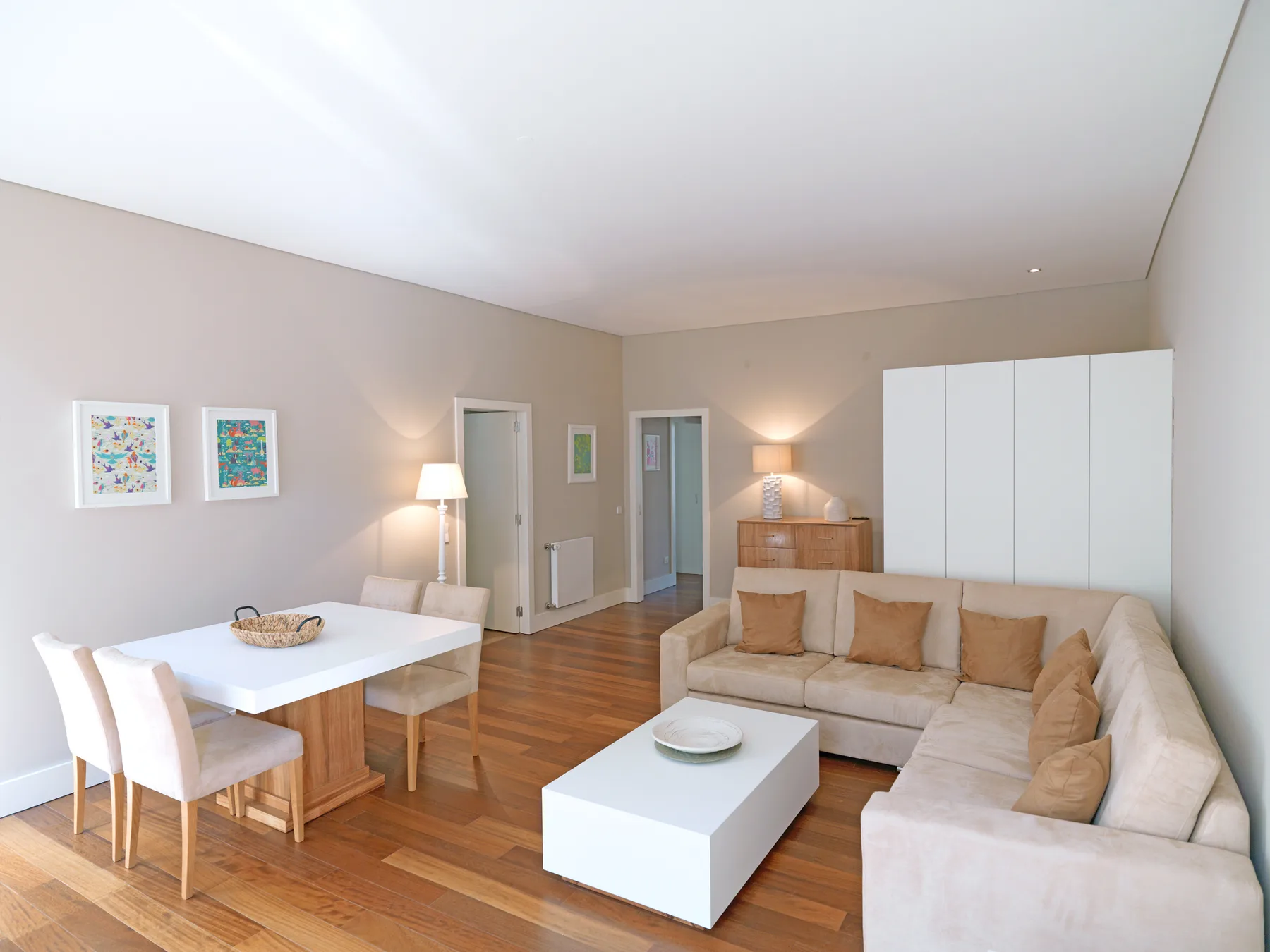 Bright living room with a dining table and seating around a coffee table.