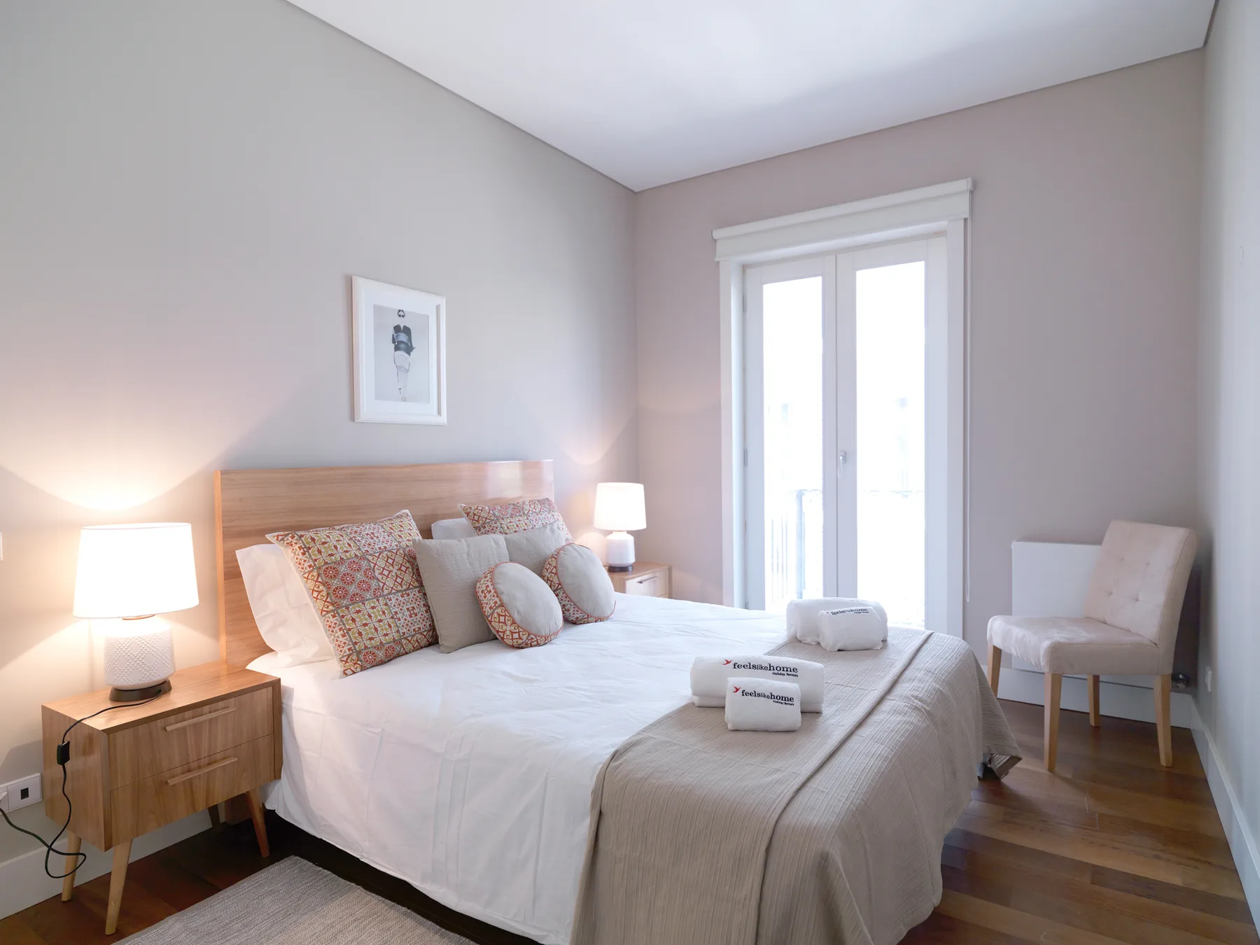 A bedroom with a neatly made bed and a glass-paned door.