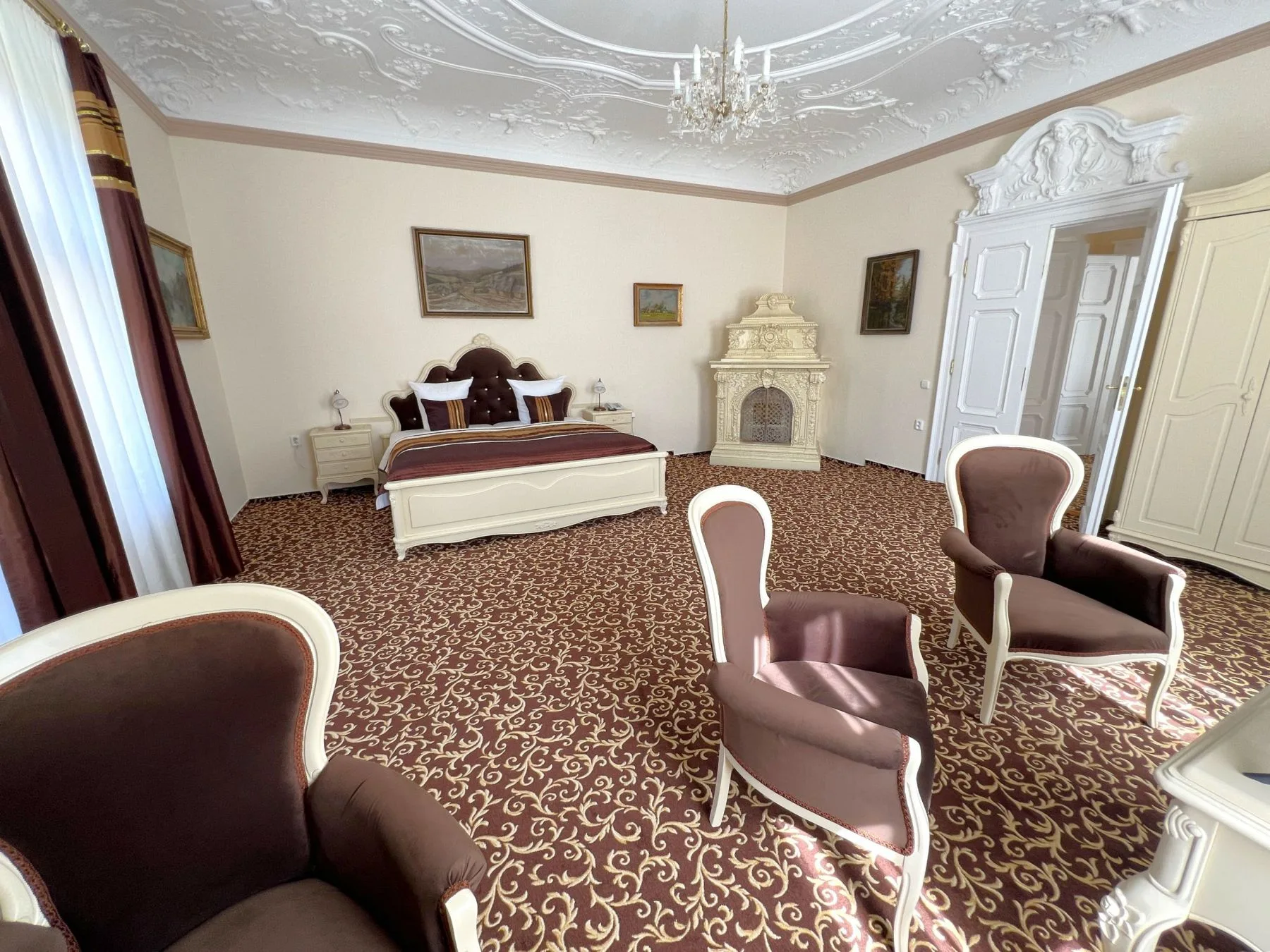 Apartment bedroom with a double bed and tiled stove