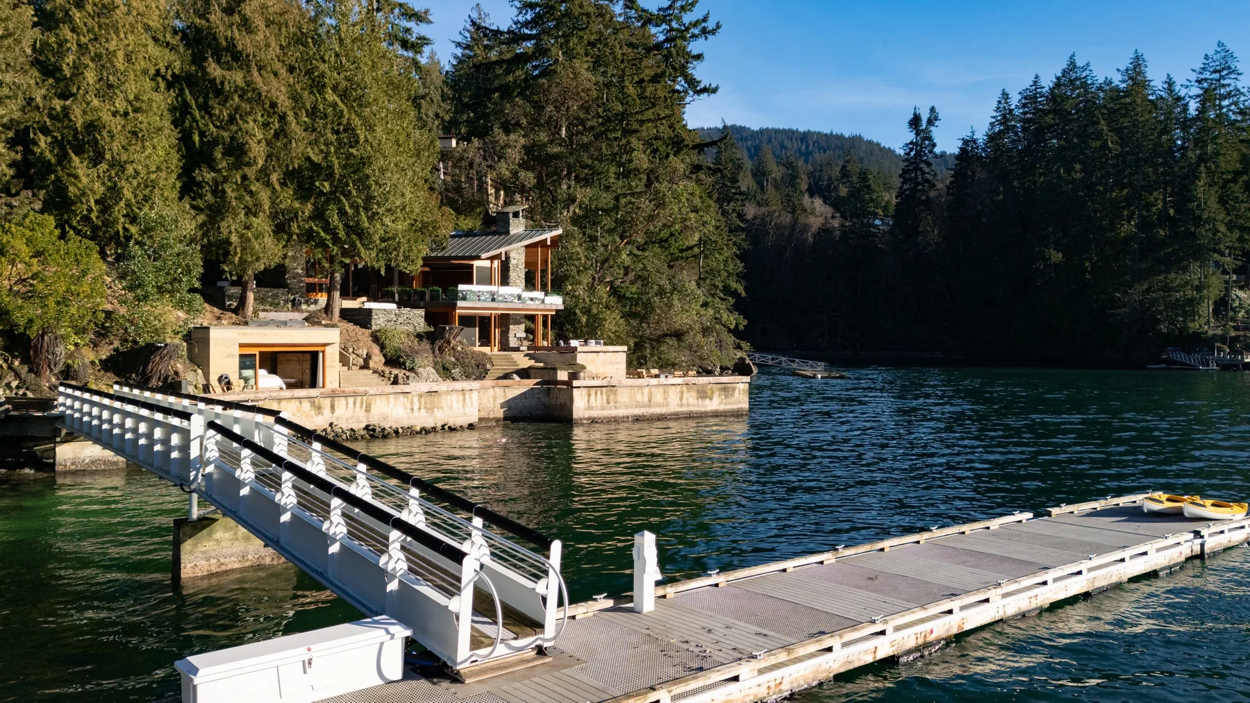 A lakeside building beside a floating dock and a sloped access ramp.