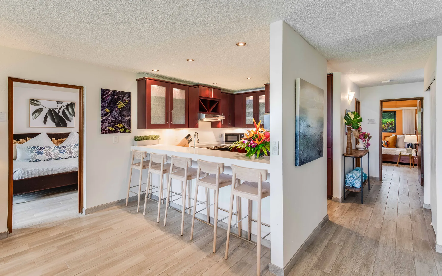 An open kitchen and dining area with a counter and bar seating.
