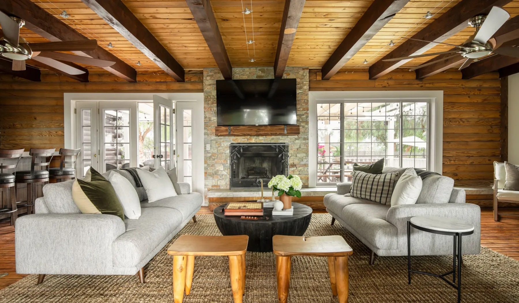 A living room with seating arranged around a fireplace and coffee table.