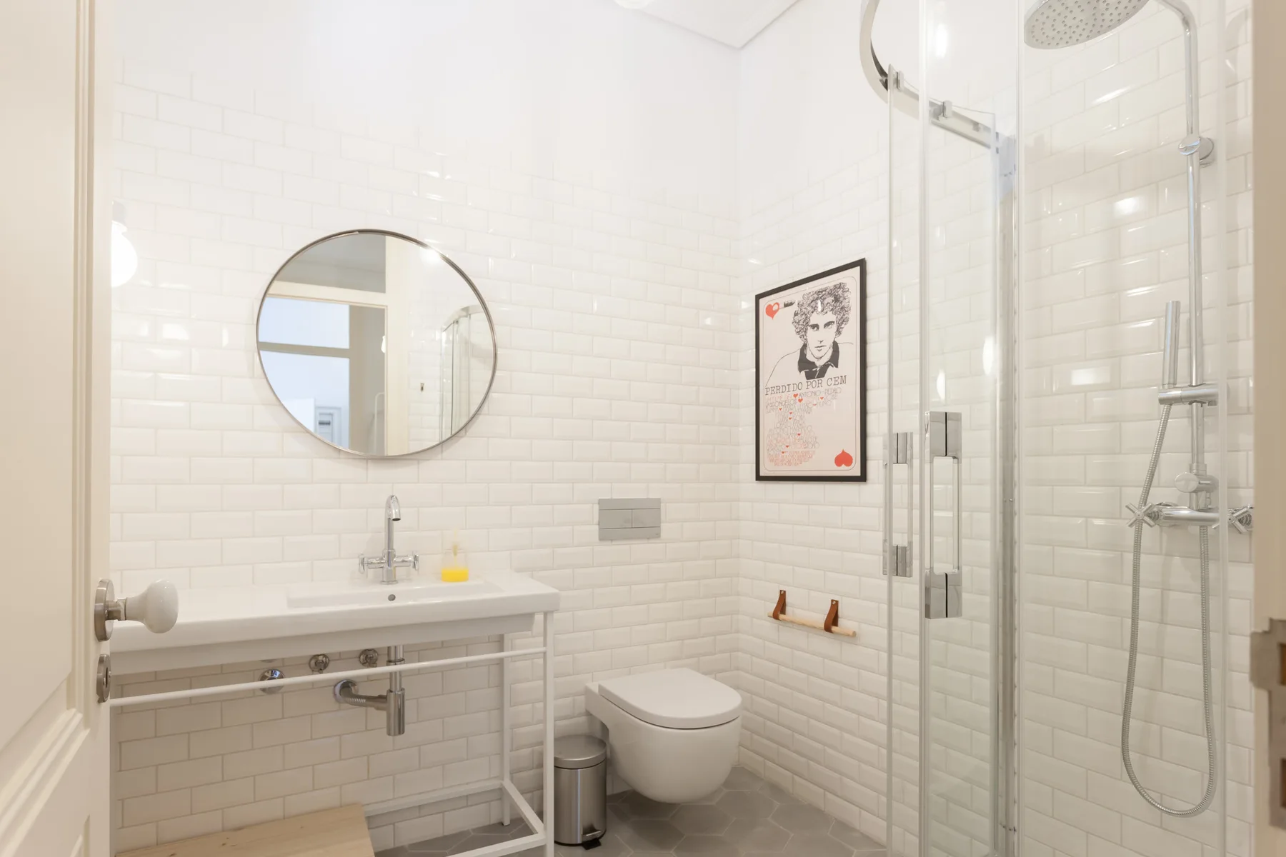 A bright bathroom with a sink, toilet, and glass shower.