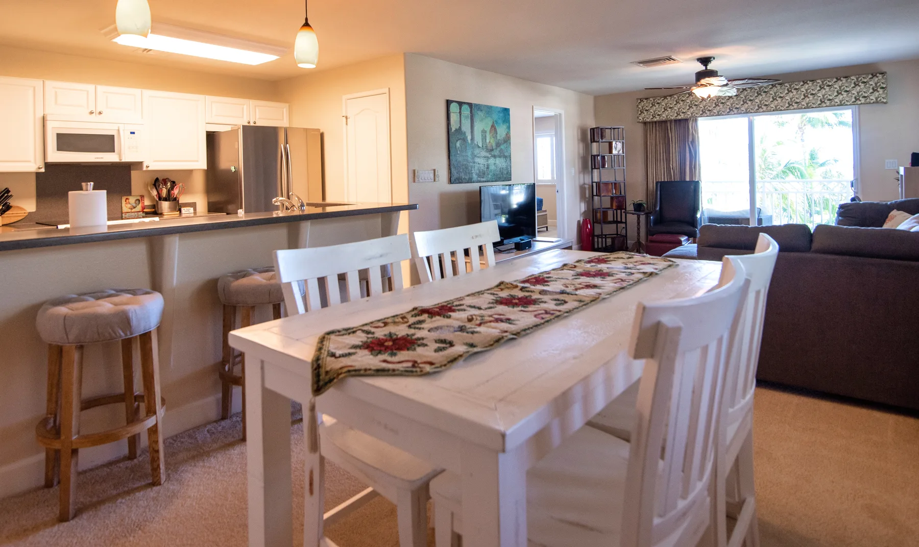 An open-plan living and dining area with a kitchen counter and dining table.
